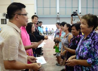 Deputy Mayor Wattana Chantanawaranon presents financial aid to Pattaya-area residents affected by flooding over the past year.